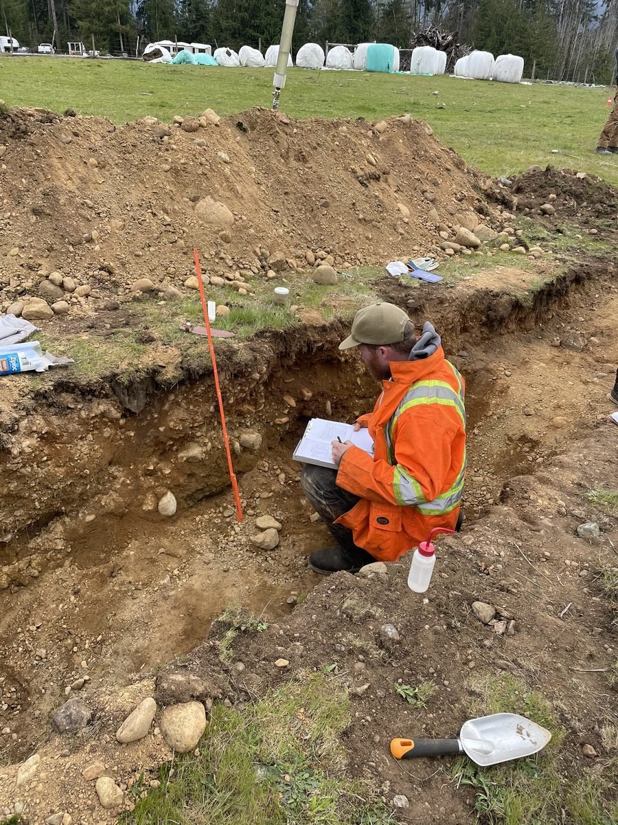 Reid Graham in a test pit recording soil data on a Vancouver Island property